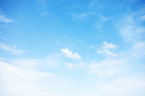 Blue sky background and white clouds soft focus, and copy space.